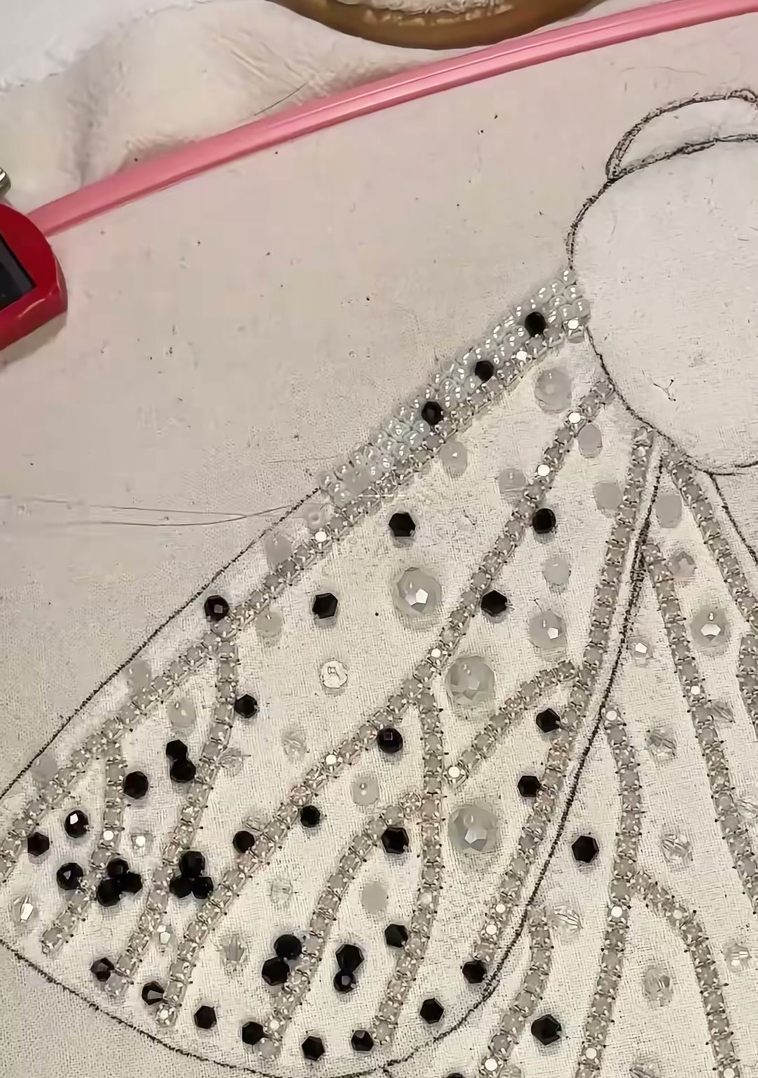 Step 08 — A close-up of one wing almost completely covered in silver seed beads, with black spots scattered throughout