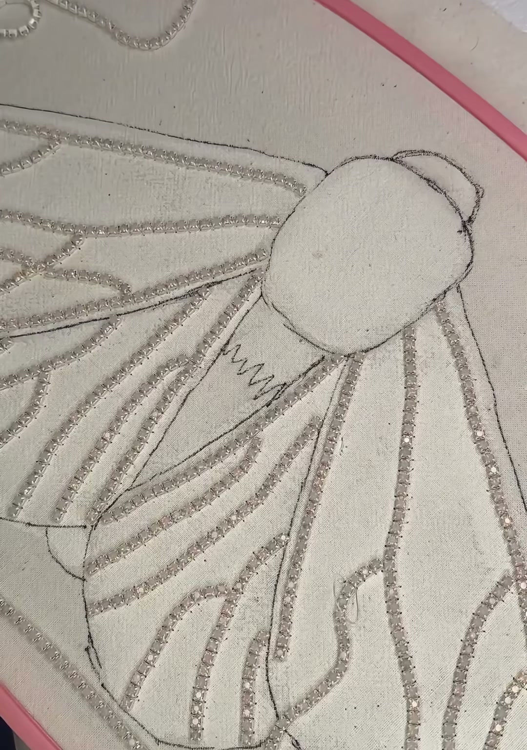 Step 03 — Silver seed beads stitched in flowing lines across the wings, creating the moth's veined pattern