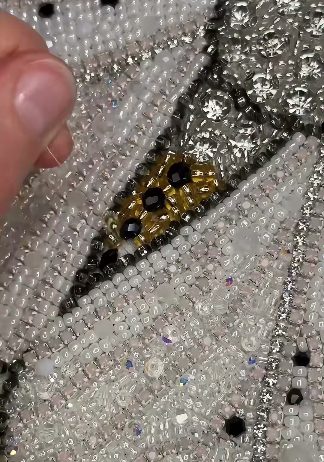 Step 16 — The lower abdomen covered in antique gold seed beads with black accents, creating a striped effect