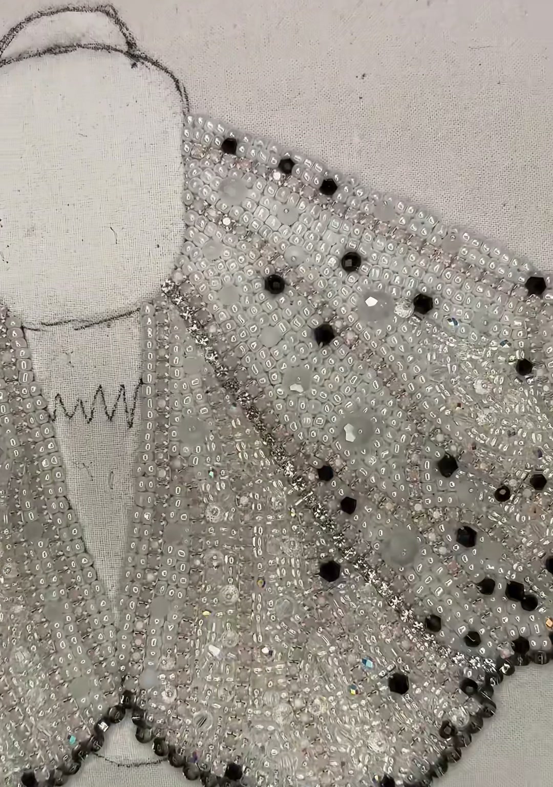 Step 14 — The moth's thorax covered in clear rhinestones and silver beads, creating a glittering central body