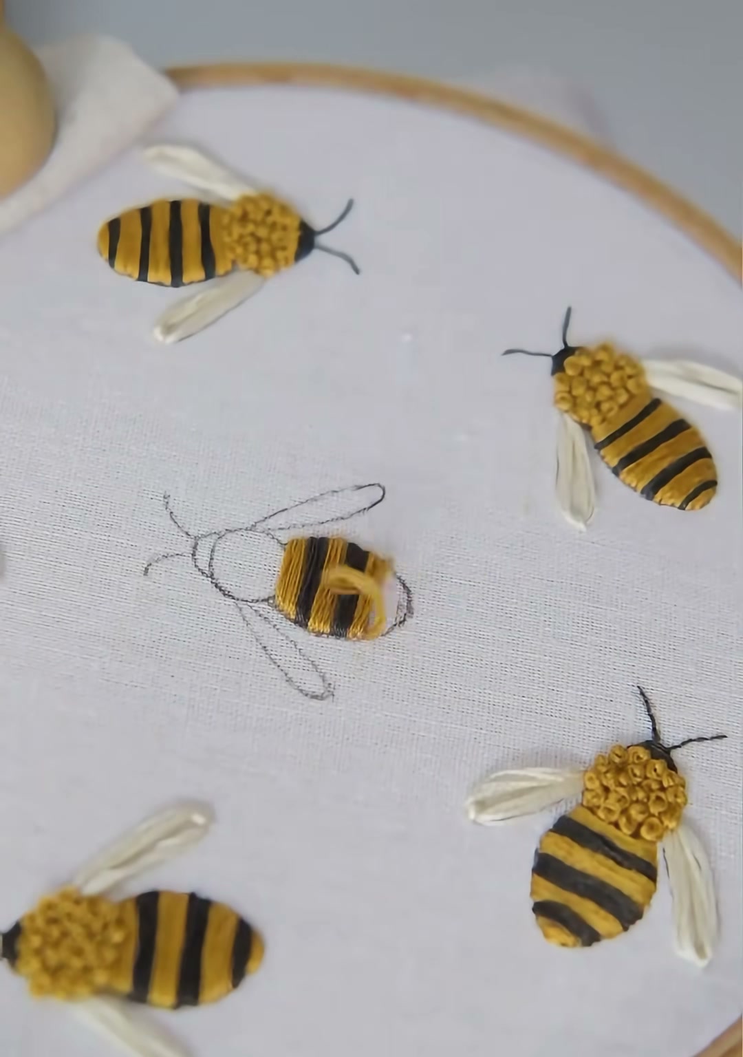 Step 02 — The bee body partly covered in yellow satin stitches