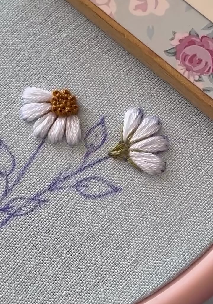 Both daisies with stems and leaves fully stitched