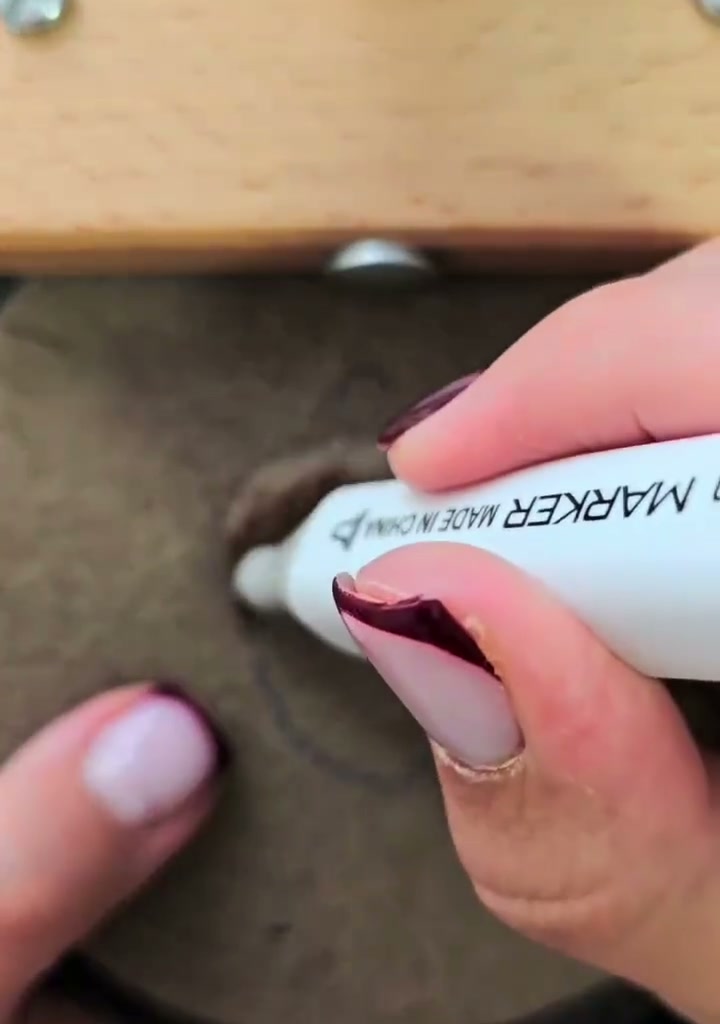 Step 11 — The top cap of the acorn being colored with the brown marker