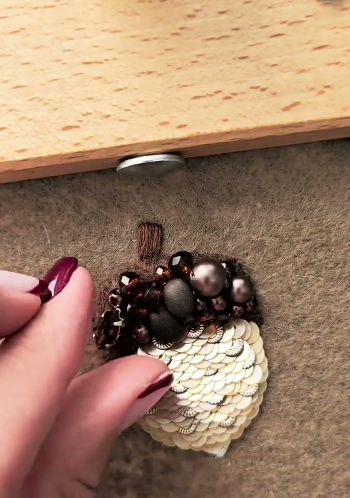 Step 17 — Close-up of the finished acorn showing the beaded cap and sequin scales