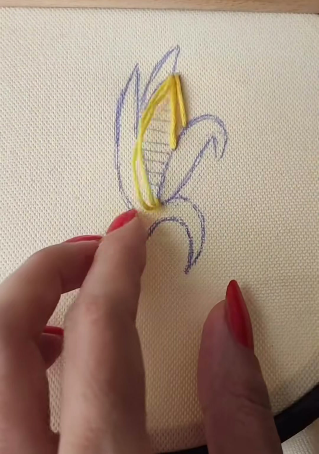 Step 2 — The first few yellow straight stitches laid down along the center of the corn outline