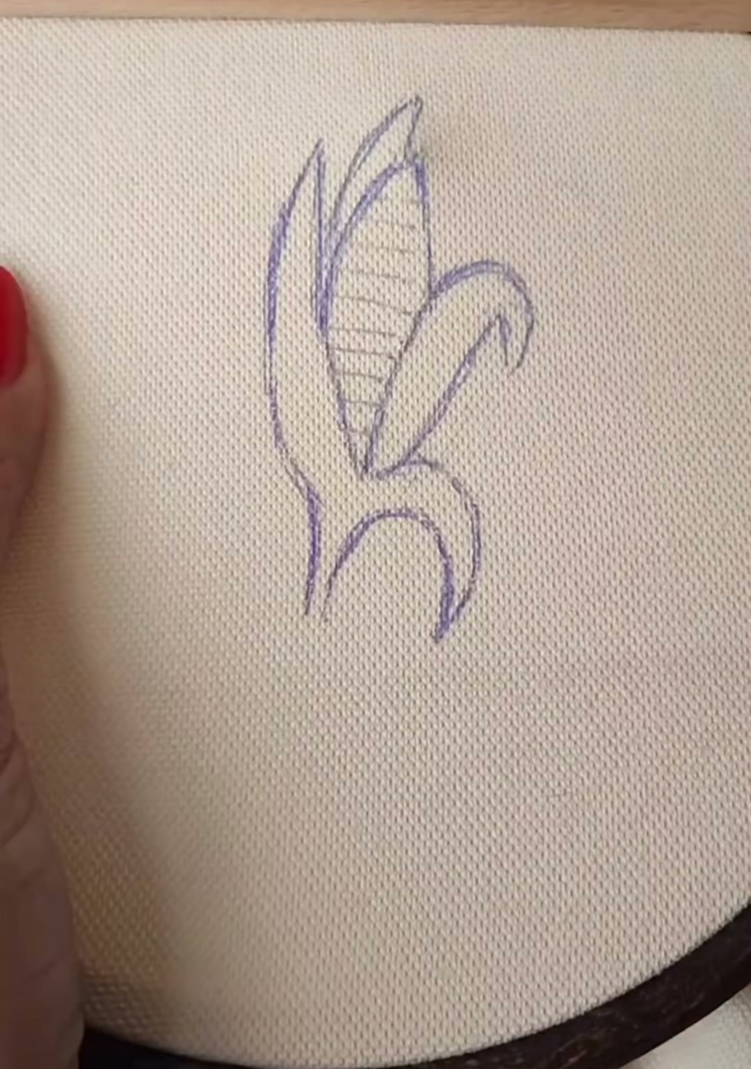 Step 1 — A simple corn outline drawn on fabric with a water-soluble marker, showing the ear and two husks