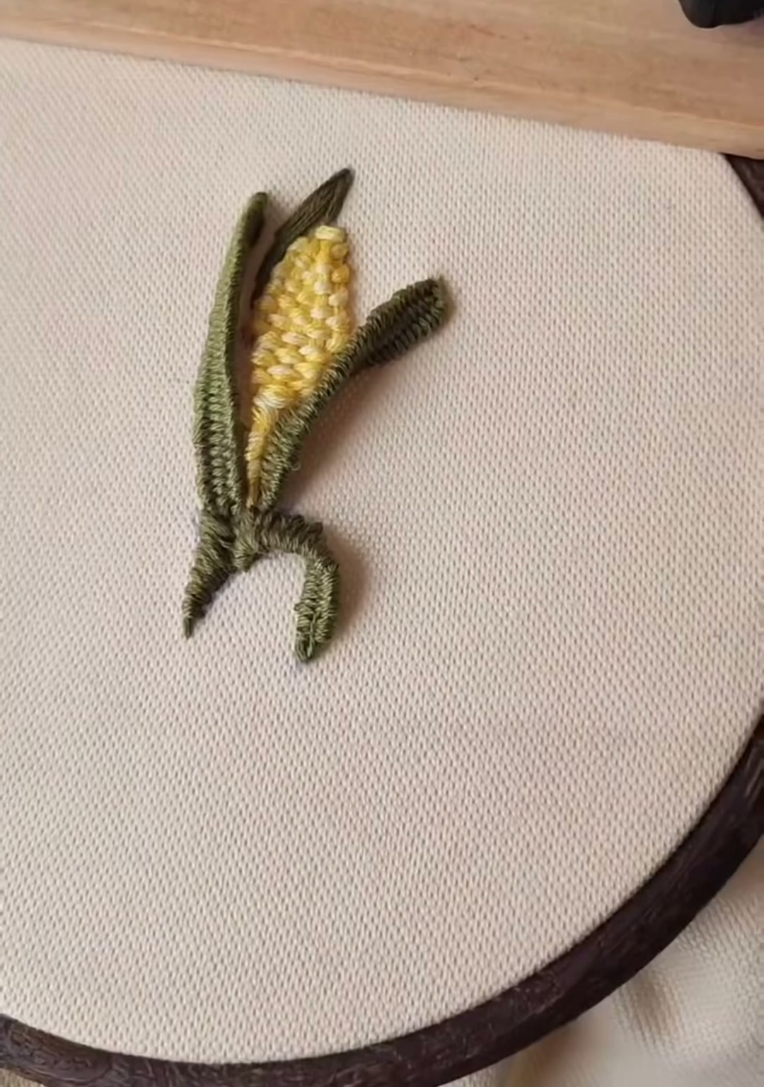 Final — The completed 3D embroidered corn in its hoop, golden and green