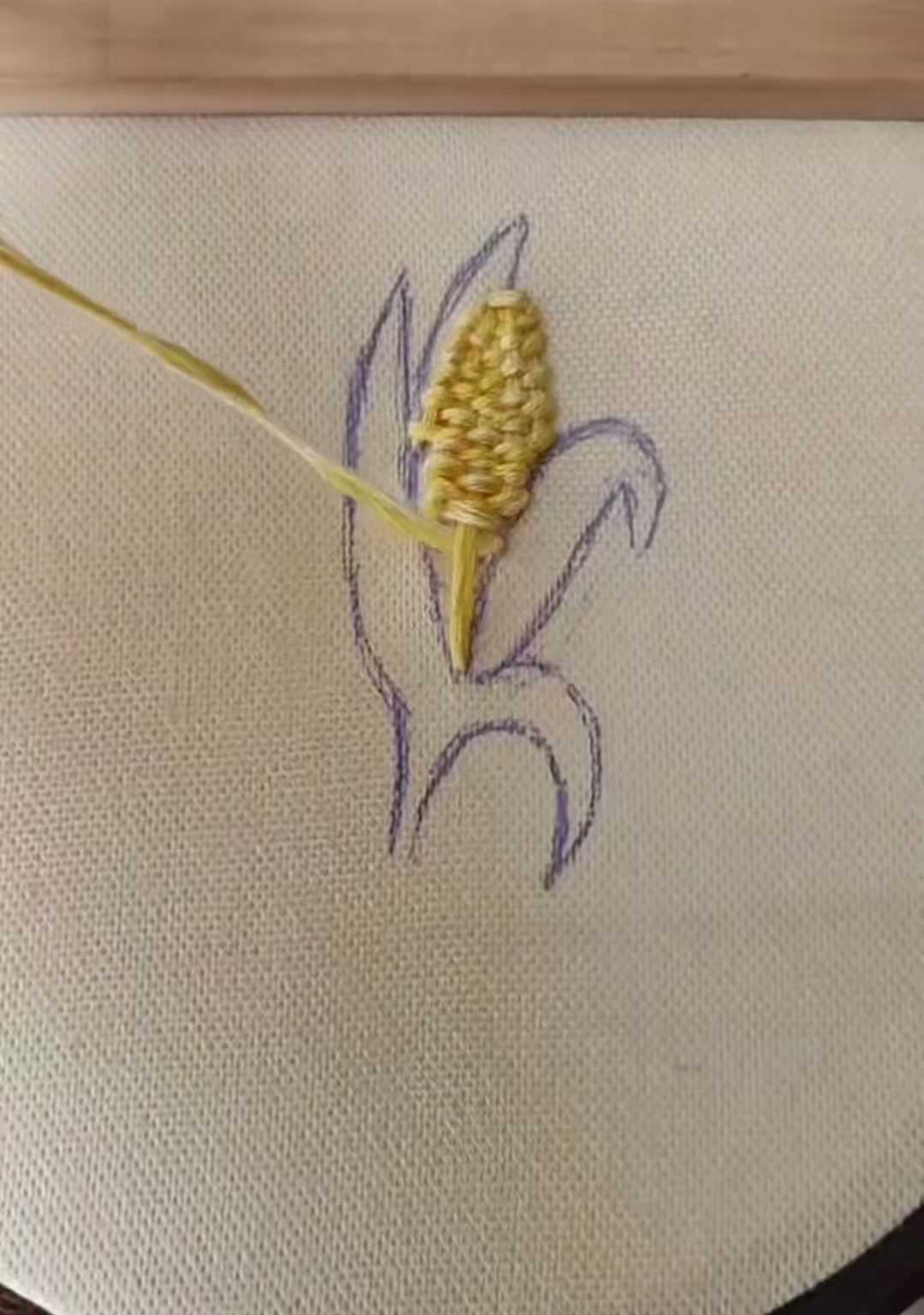 Step 6 — The full corn ear covered in smooth yellow stitching, ready for the green husks