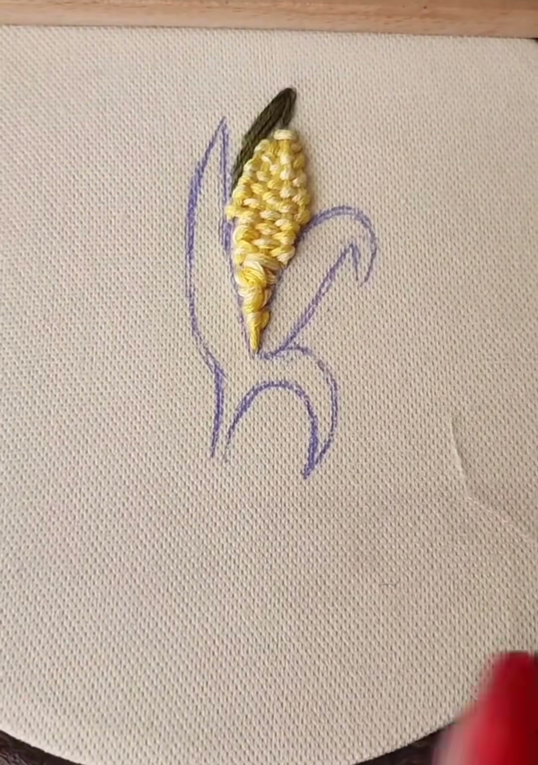 Step 8 — A pink pin holding the second husk area in place while the green thread is prepared