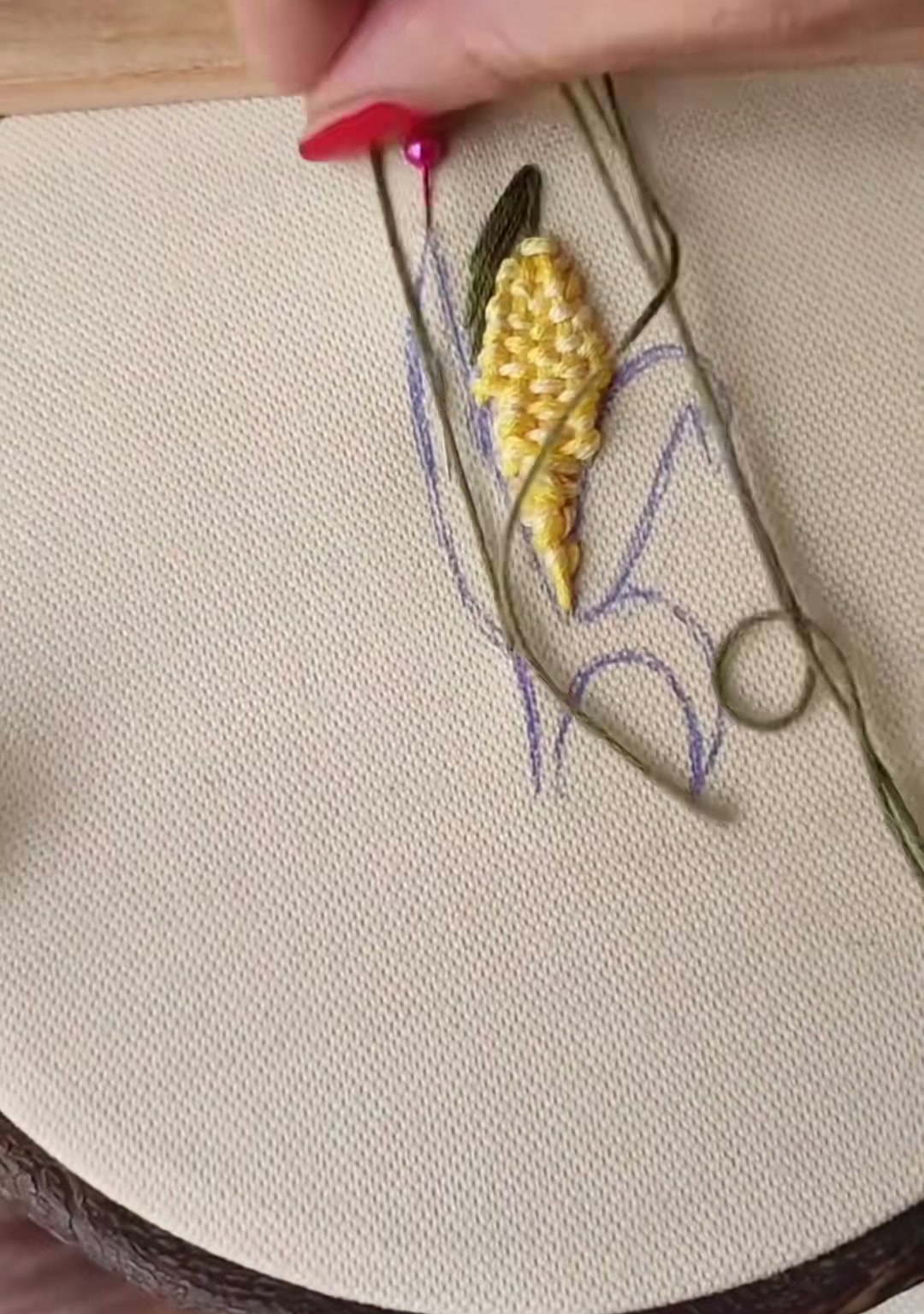 Step 9 — The right husk partially filled with olive green satin stitch