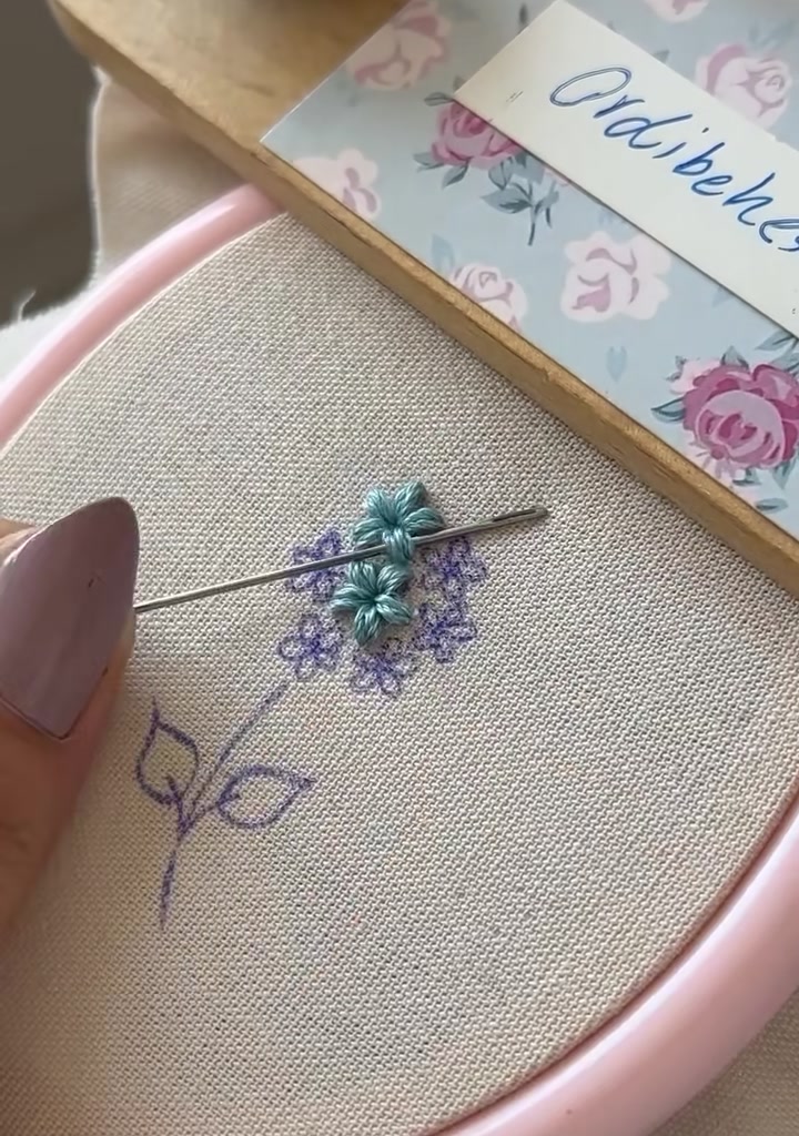 Needle tucking in extra stitches between existing flowers